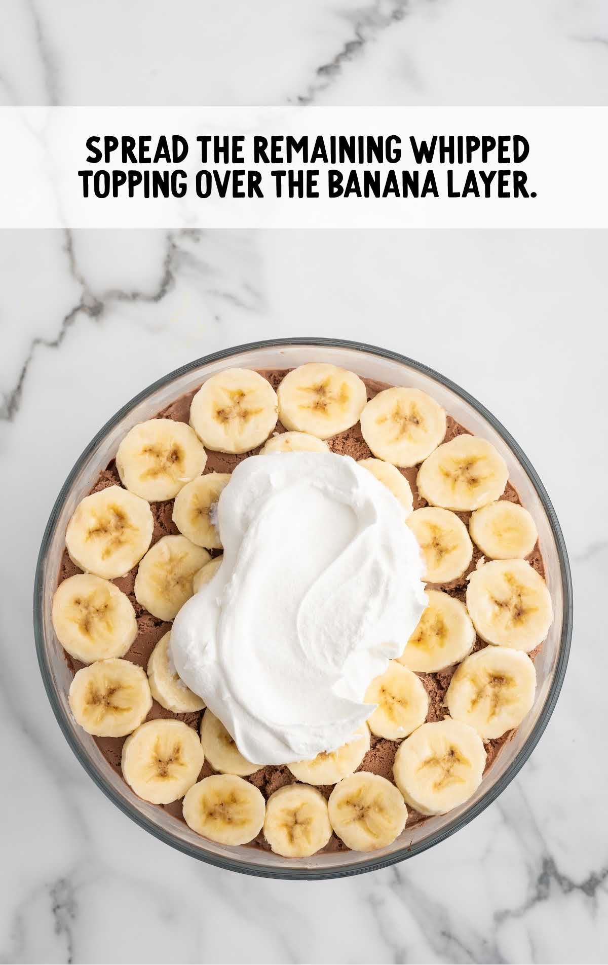 whipped topping spread over the banana layer