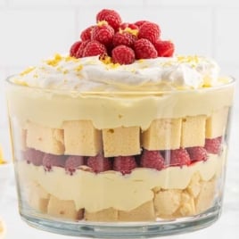 a trifle jar of Lemon Raspberry Trifle topped with raspberries and lemon zest