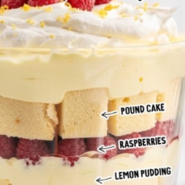 a trifle jar of Lemon Raspberry Trifle topped with raspberries and lemon zest