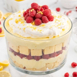 a trifle jar of Lemon Raspberry Trifle topped with raspberries and lemon zest