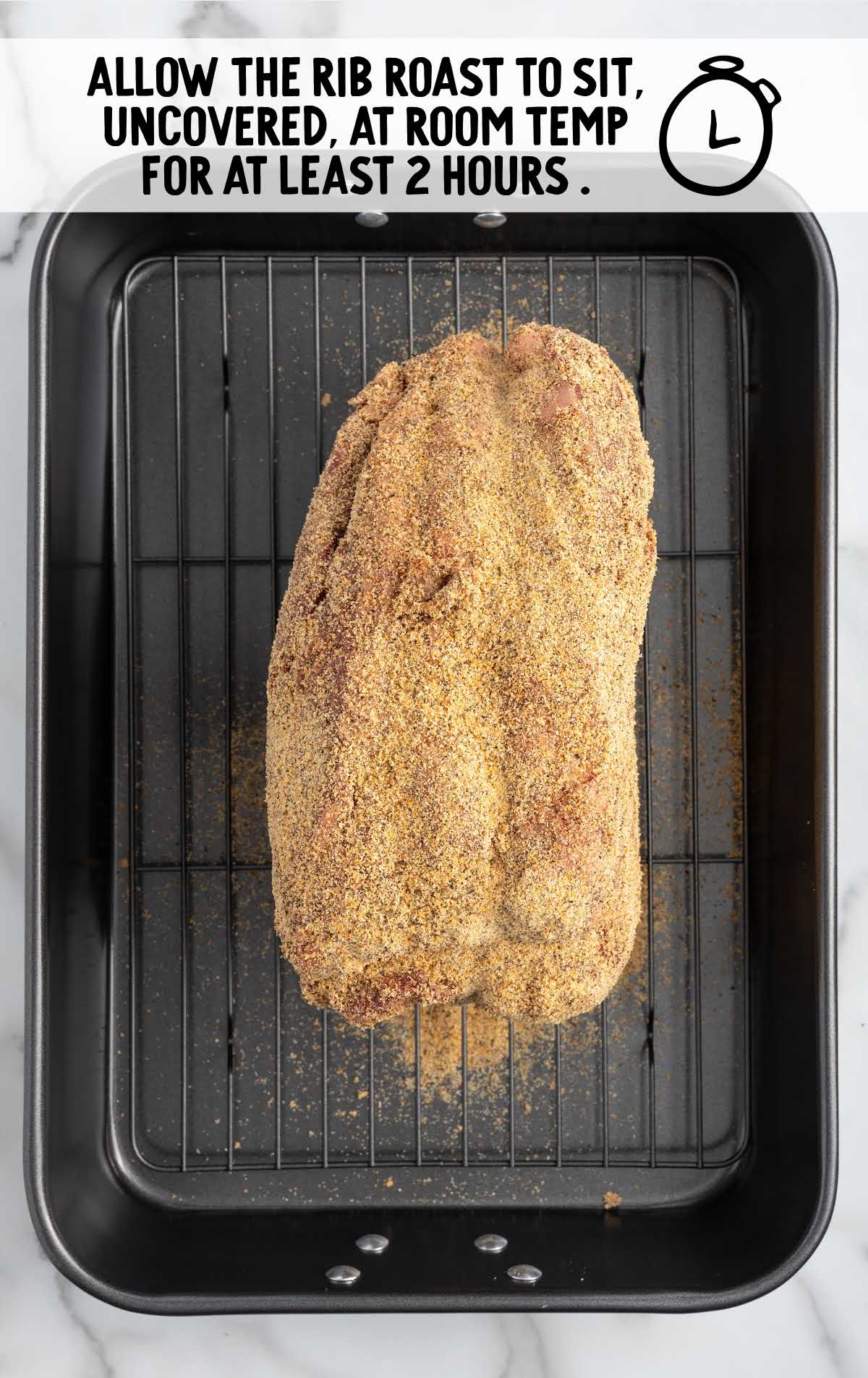 seasoned prime rib on a roasting pan