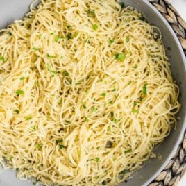 a skillet of Parmesan Noodles garnished with parsley