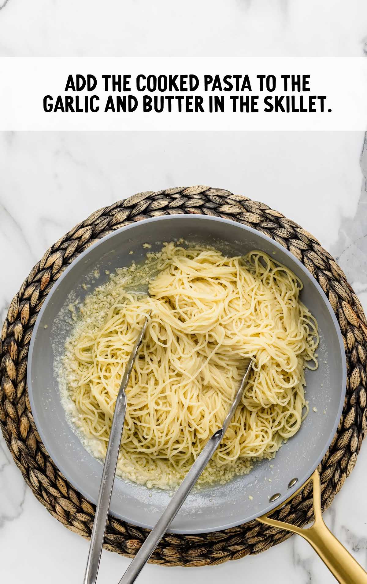 cooked pasta added to the garlic and butter in the skillet