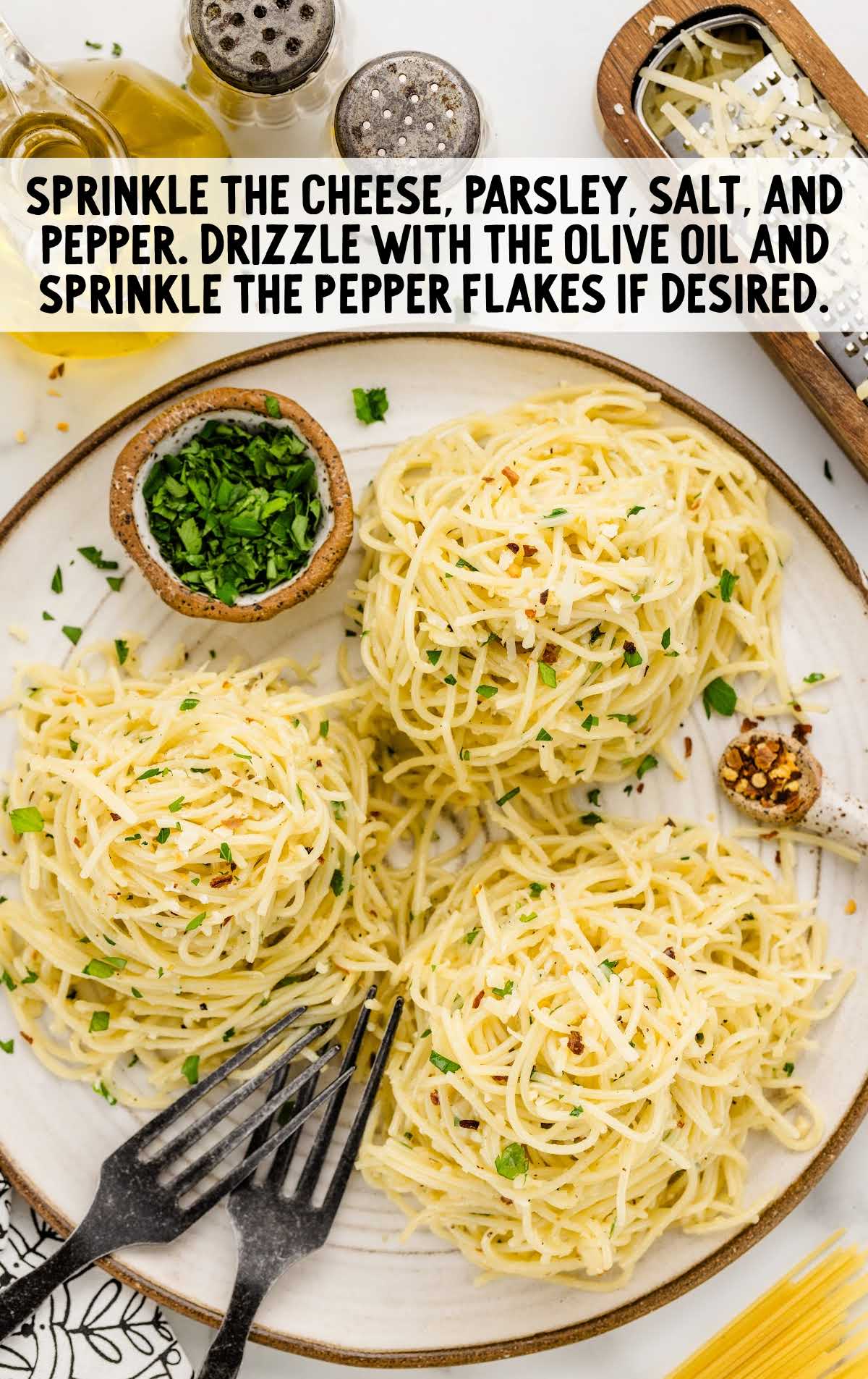 pasta topped with parmesan cheese, parsley, salt, and black pepper