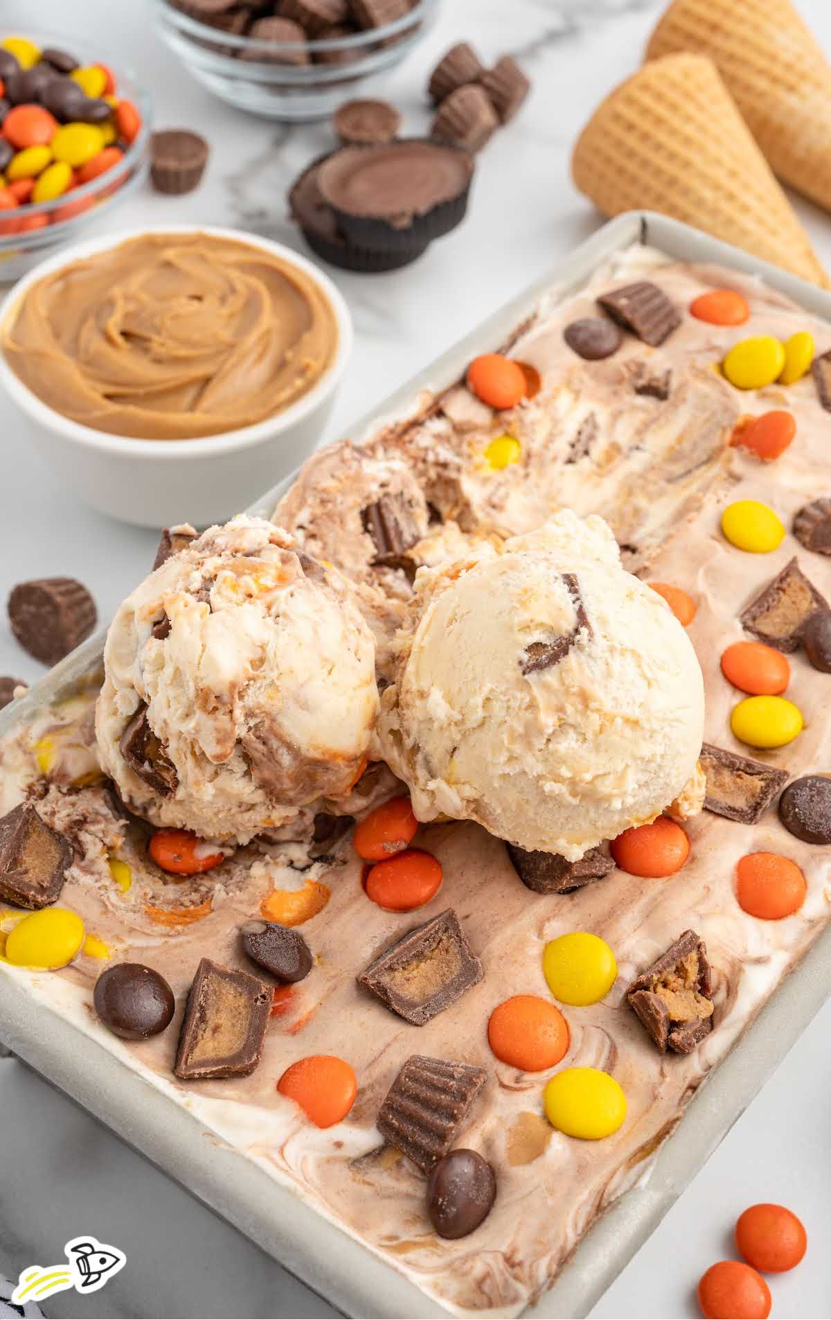 scoops of Peanut Butter Cup Ice Cream on top of the ice cream in a pan