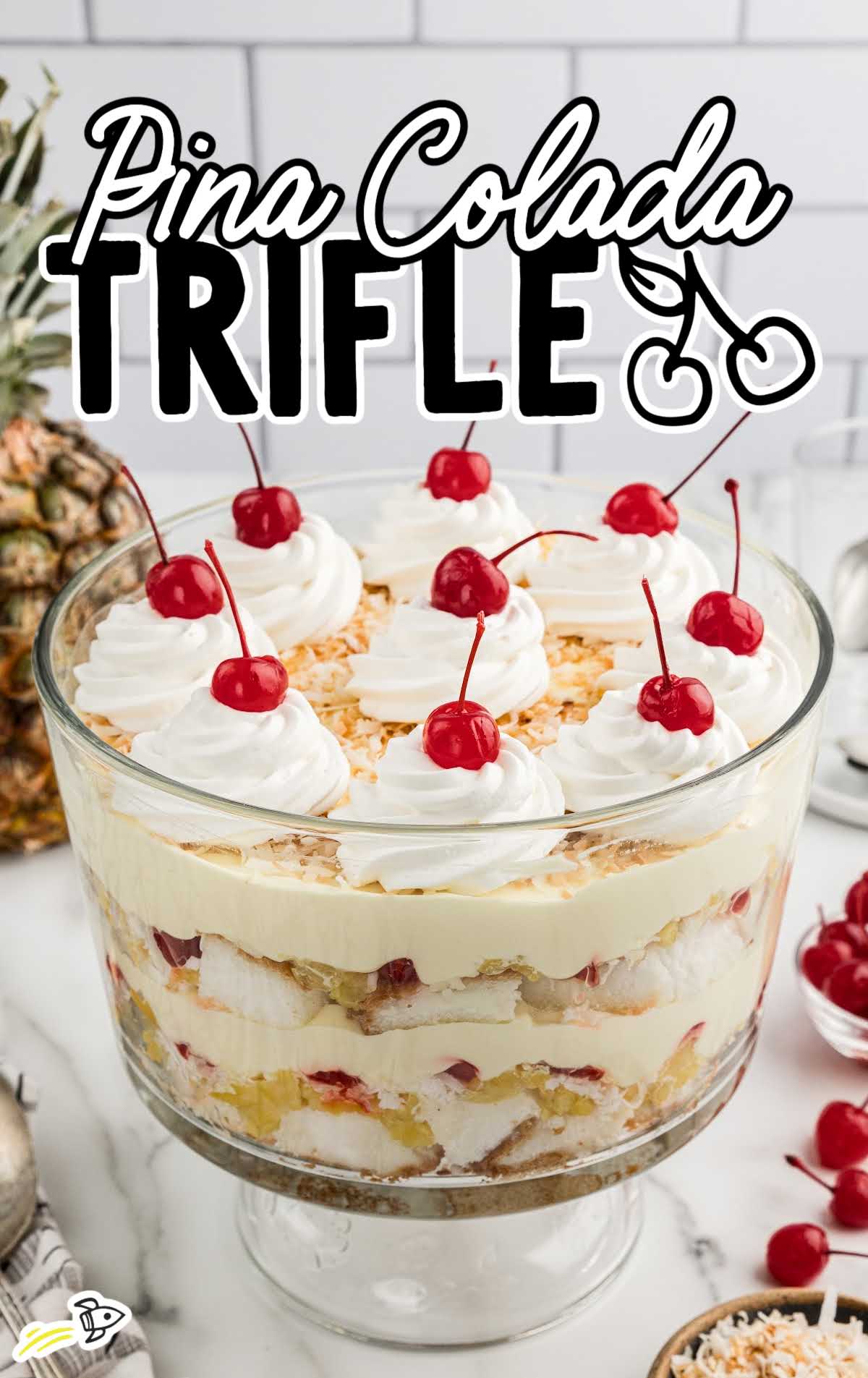 Pina Colada Trifle topped with whipped topping and cherries