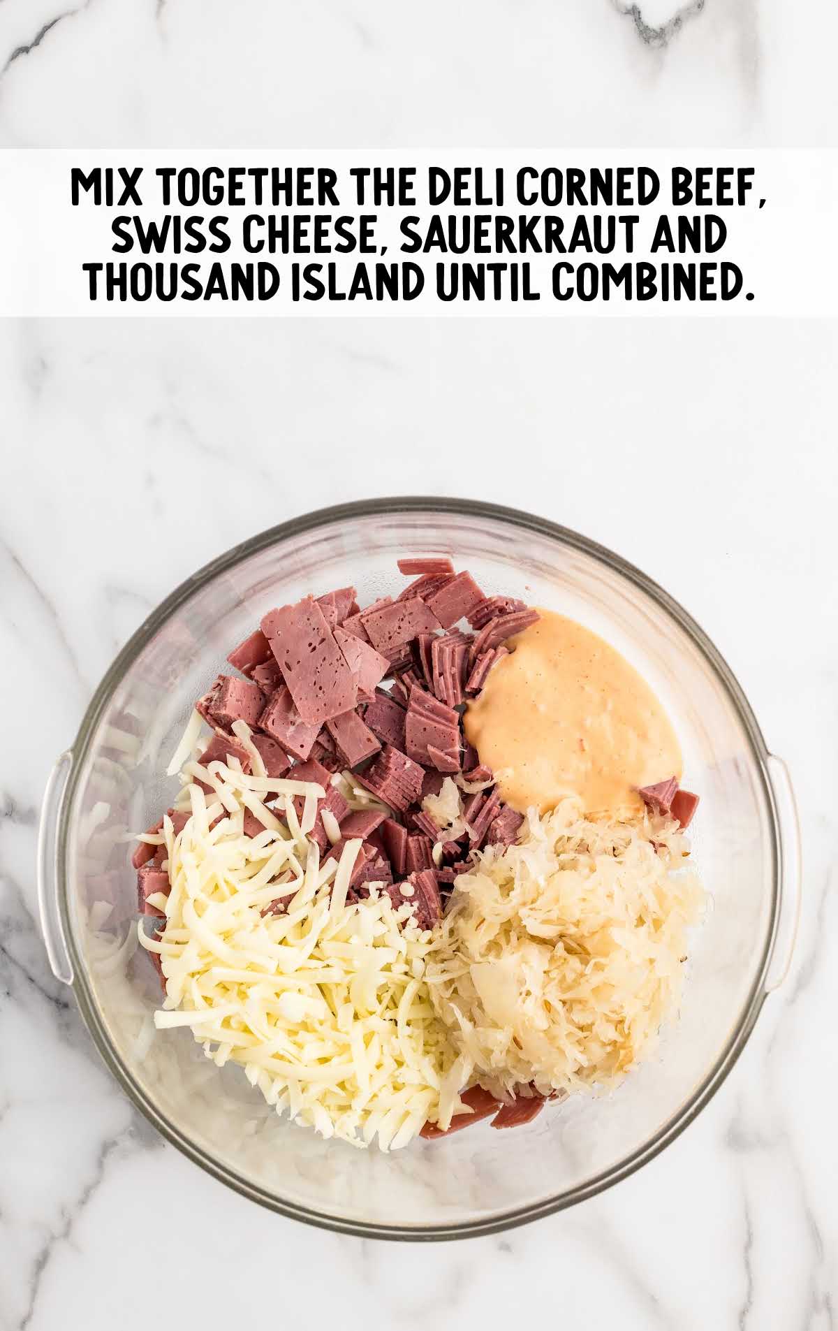 corned beef, shredded Swiss cheese, drained sauerkraut, and thousand island dressing mixed together in a bowl