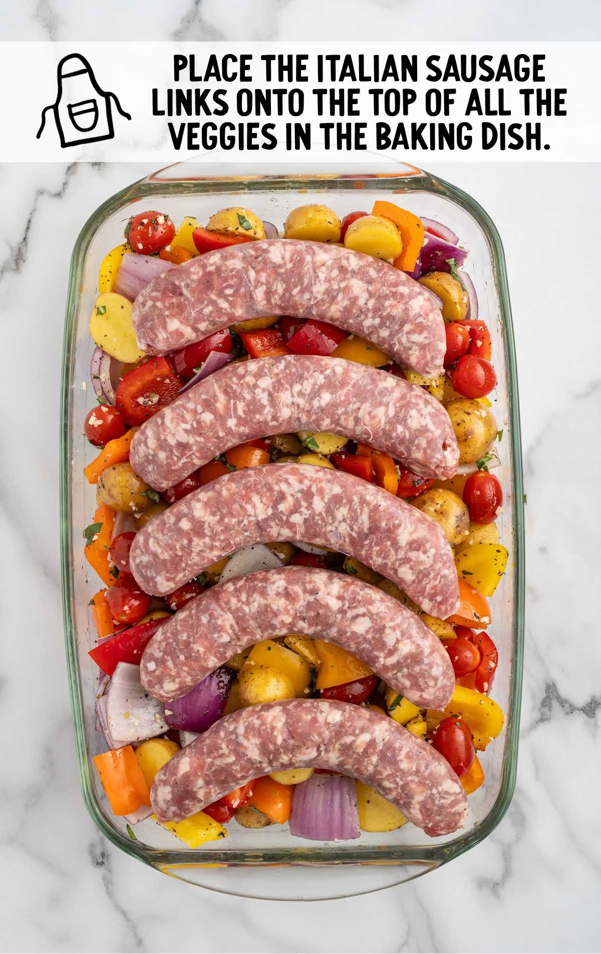 mild Italian sausage links placed on top of the vegetables in the baking dish