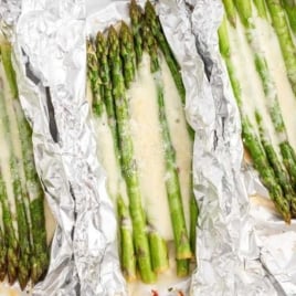 asparagus topped with melted mozzarella cheese in foil