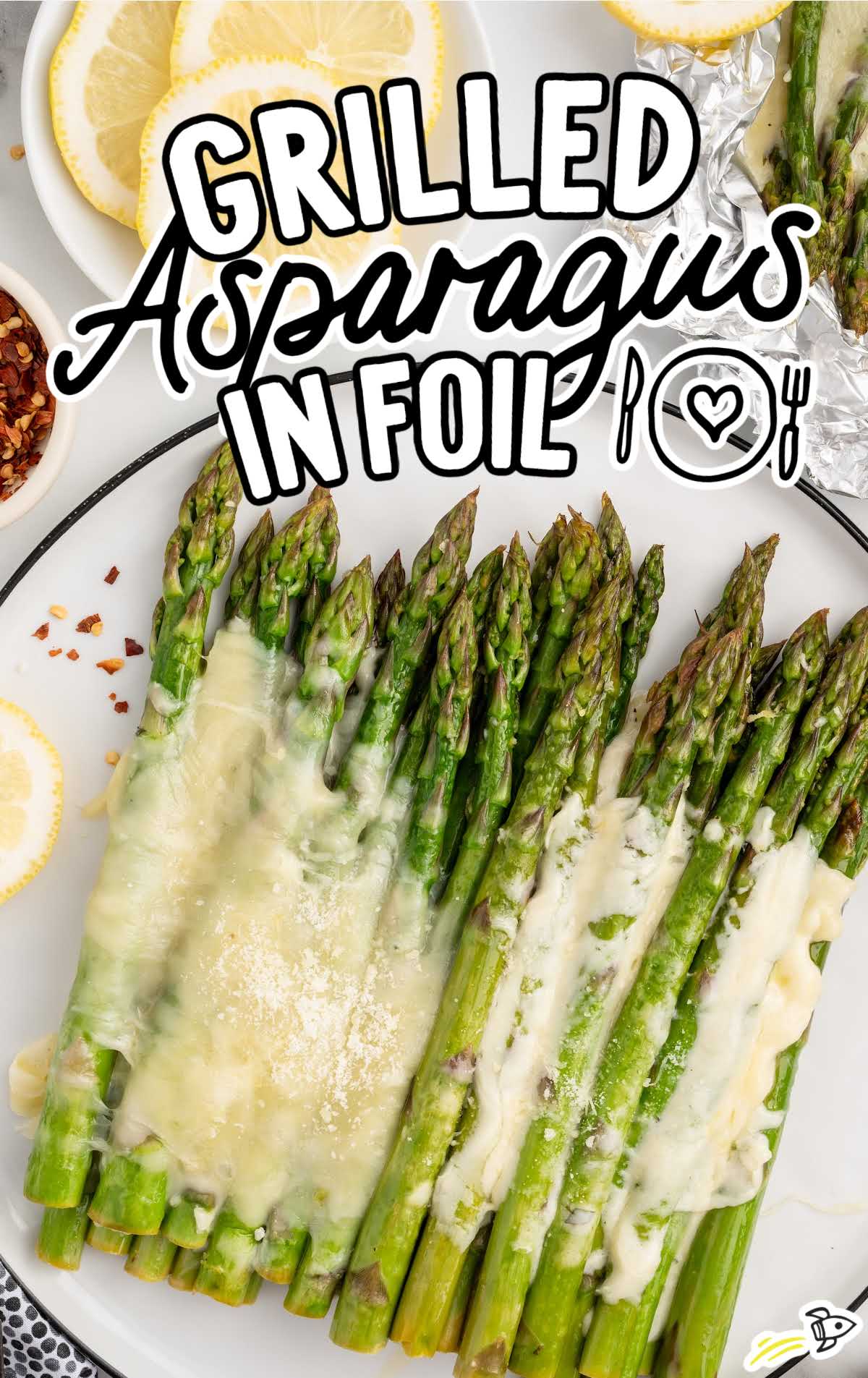 a plate of asparagus topped with melted mozzarella cheese