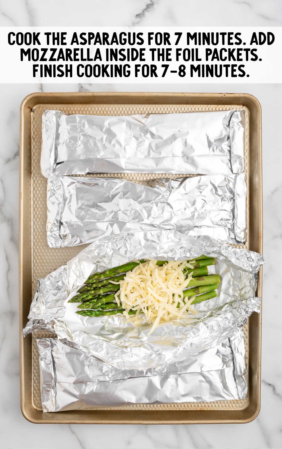 asparagus topped with shredded mozzarella cheese and wrapped in foil