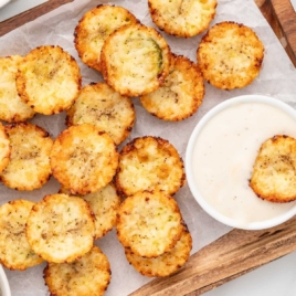 a plate of Fried Pickles with a bowl of sauce