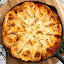 a skillet of Meatballs and Potatoes garnished with parsley