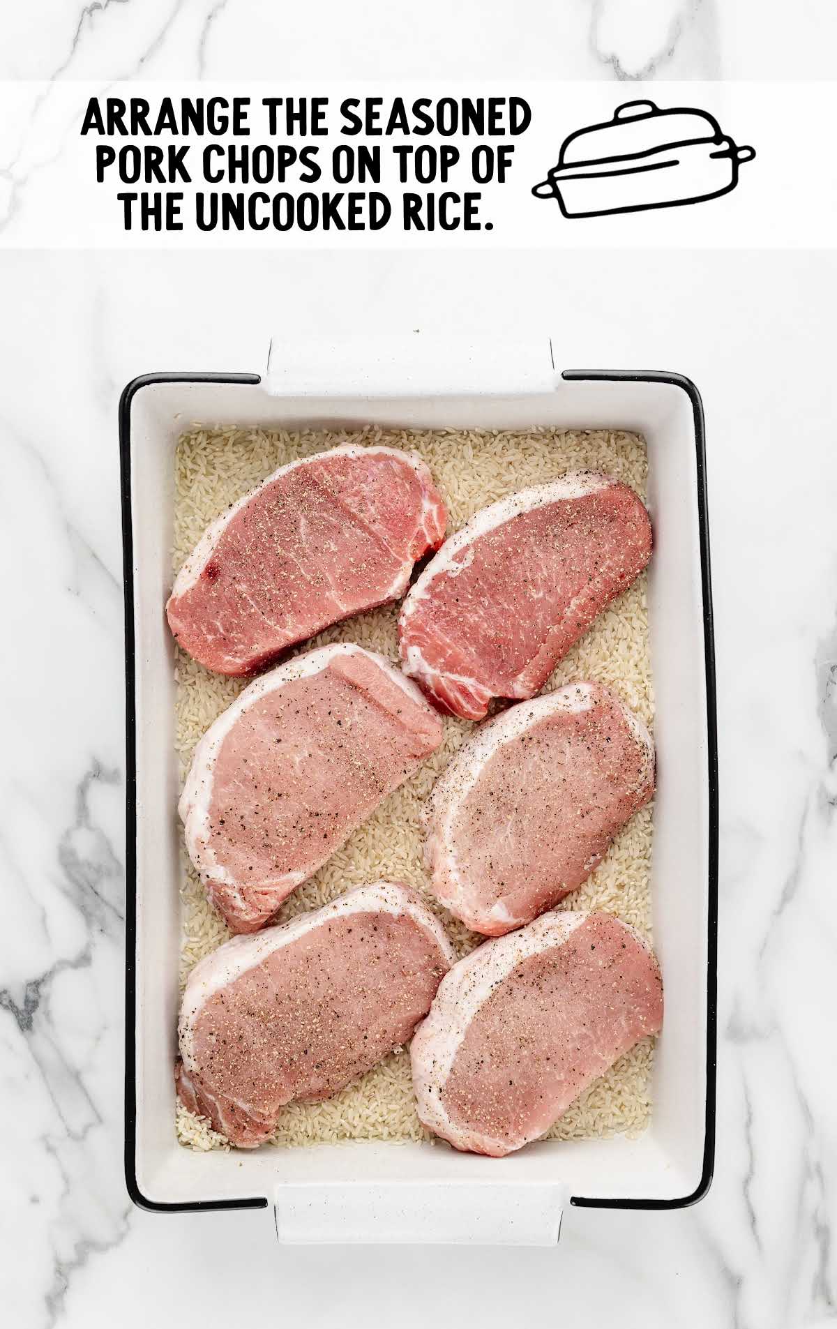 seasoned boneless pork chops placed on top of the uncooked rice in the baking dish