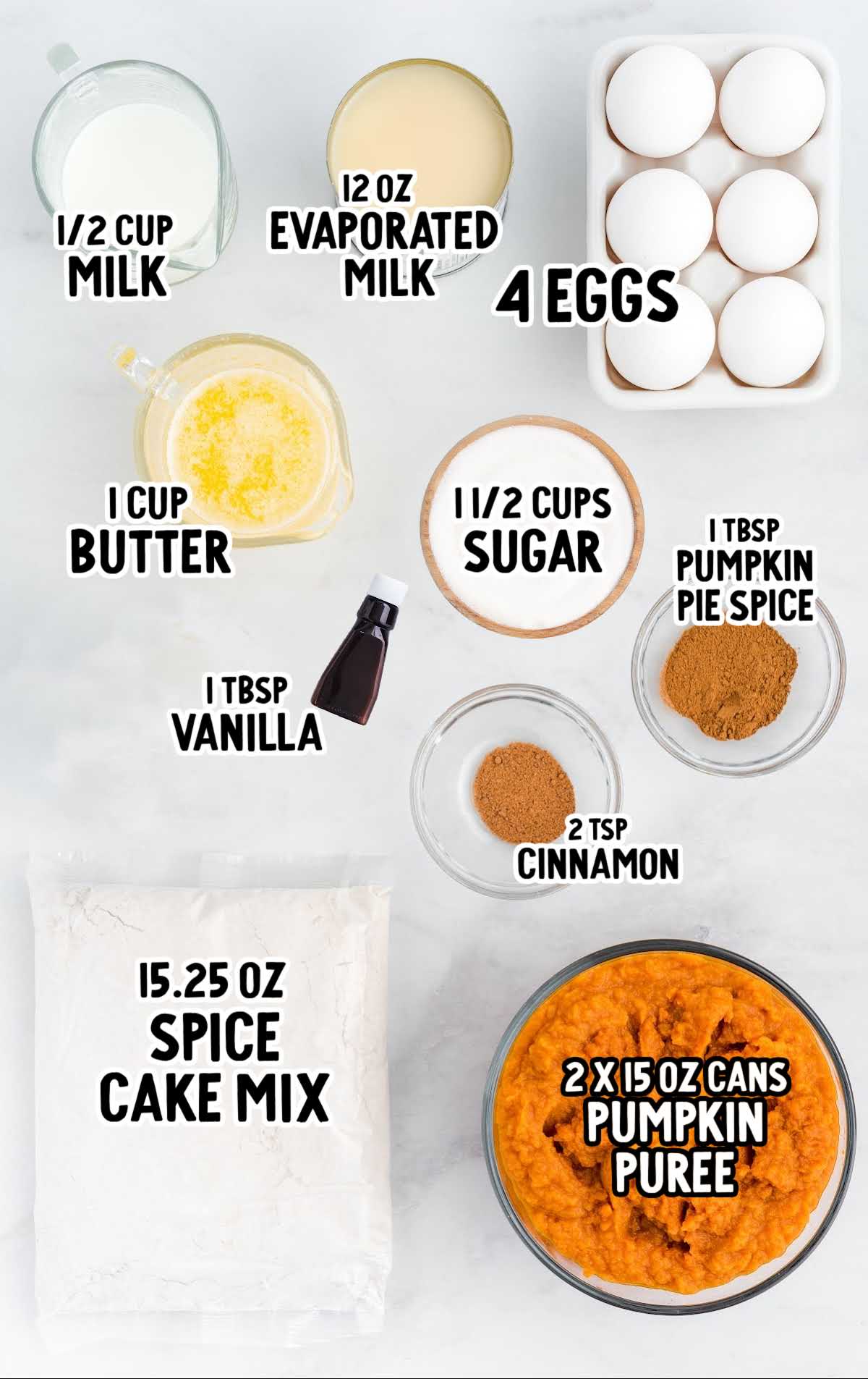 Measured ingredients for pumpkin dump cake including pumpkin puree, spice cake mix, butter, sugar, milk, eggs, spices, and vanilla.