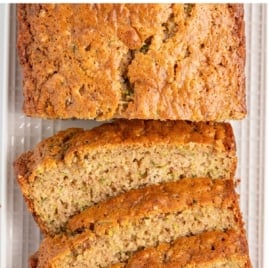 Text overlay image showing how to make zucchini bread that's light and tender with a sliced loaf below.