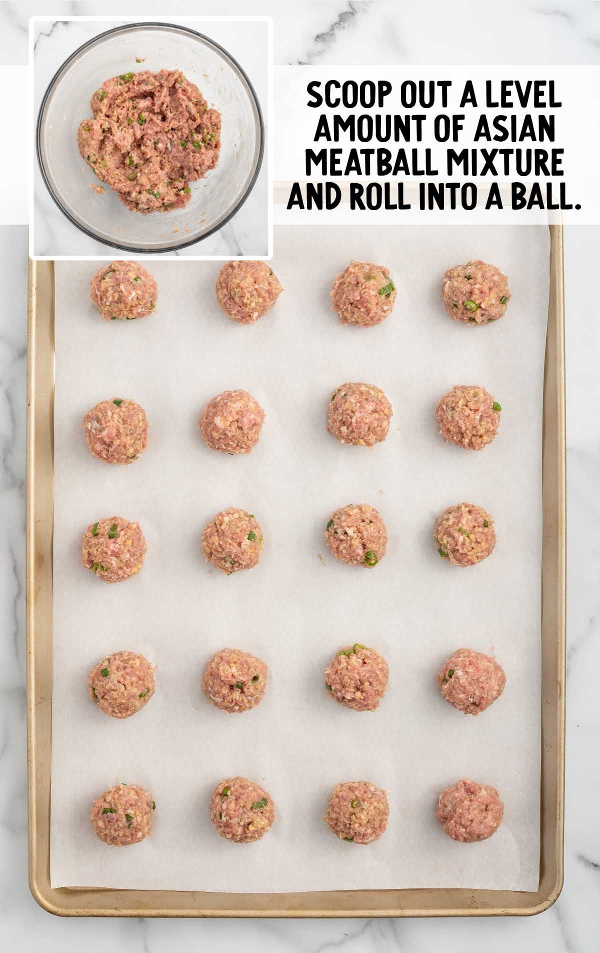 meatball mixture scooped into a ball and placed on a baking sheet