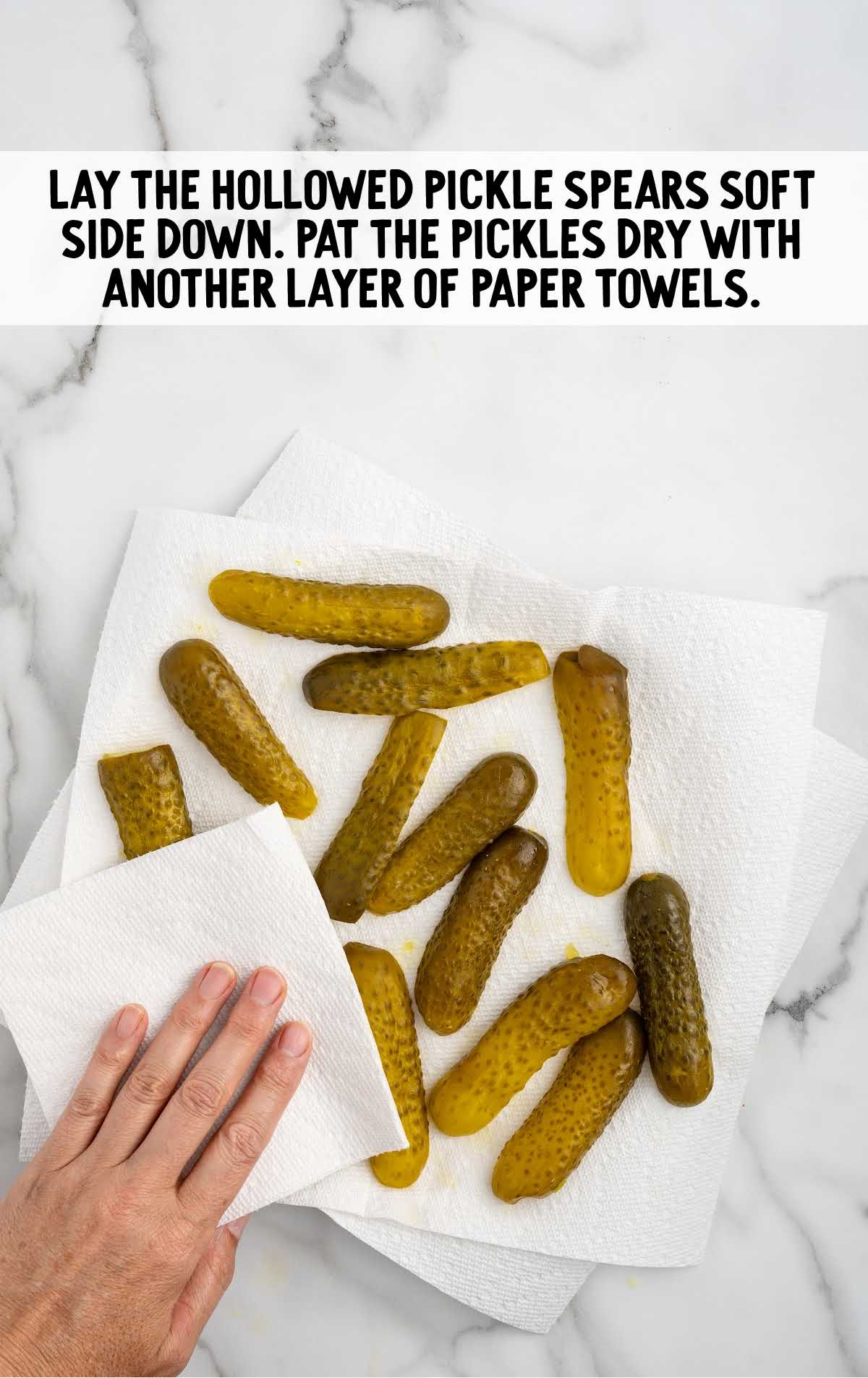 pickle spears on a paper towel