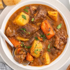 a bowl of Beef Brisket Stew topped with parsley