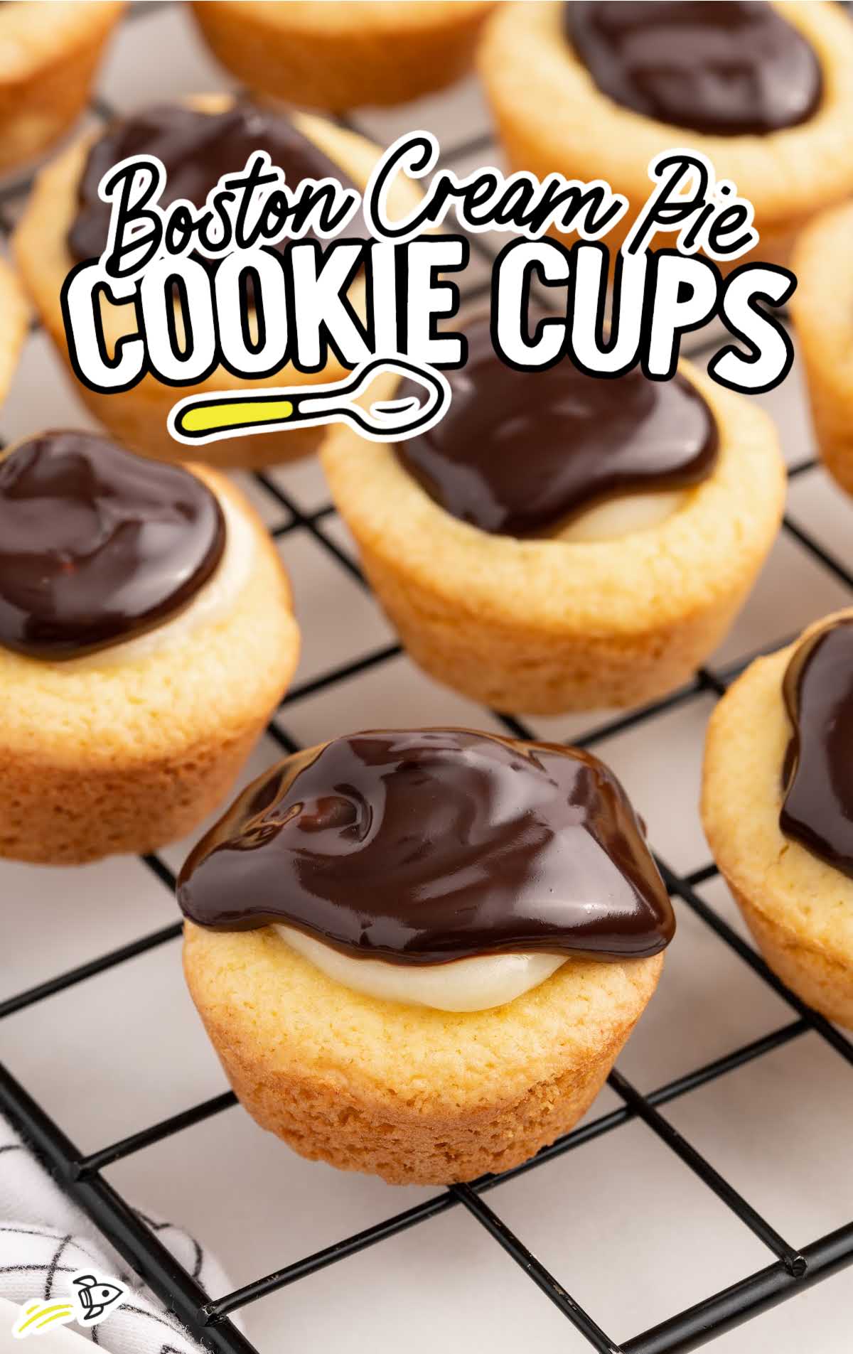 a bunch of Boston Cream Pie Cookie Cups on a cooling rack