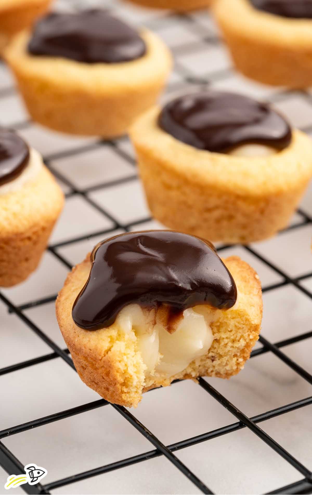 a bunch of Boston Cream Pie Cookie Cups on a cooling rack