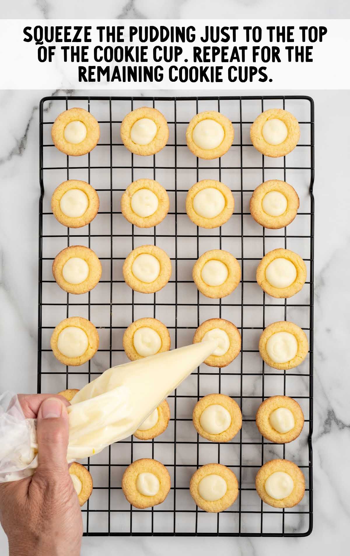 pudding squeezed into the cookie cups on a cooling rack