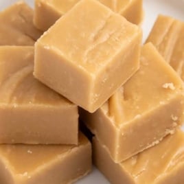 Brown Sugar Fudge stacked on top of each other on a plate