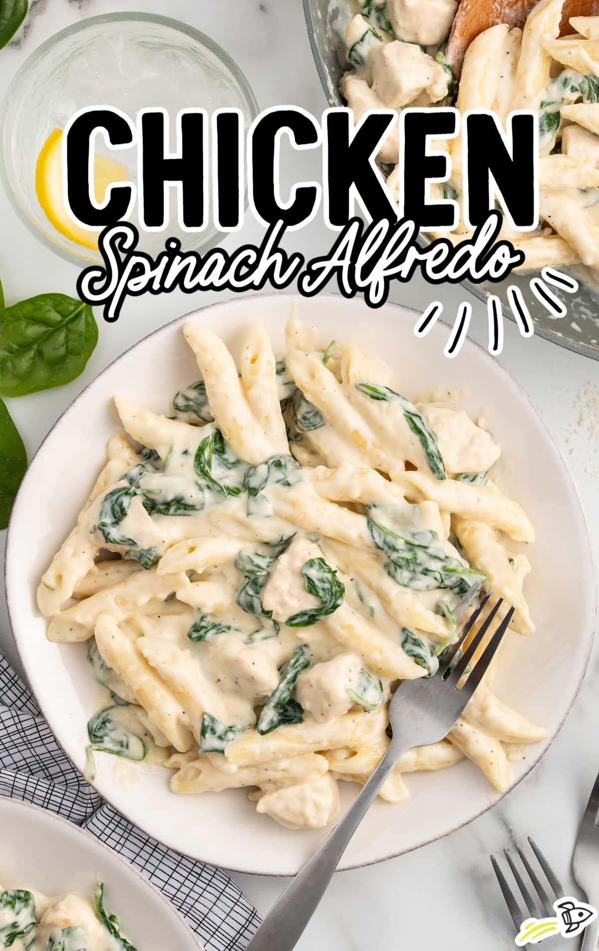 a plate of Chicken Spinach Alfredo with a fork