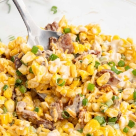 a bowl of Cracked Corn Salad with a spoon