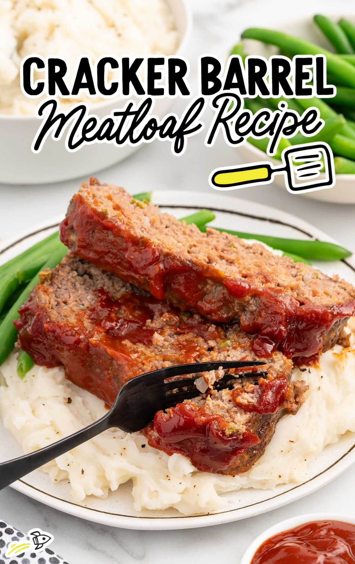 meatloaf served with mashed potatoes and green beans on a plate