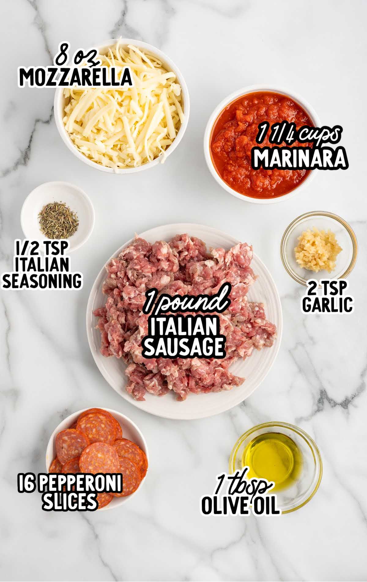 Flat lay of labeled ingredients for crustless pizza including Italian sausage, marinara, mozzarella, pepperoni, garlic, olive oil, and seasoning.