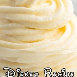 A swirl of creamy Dole Whip dessert in a glass, with text overlay reading Disney Recipe Dole Whip and decorative stars around the wordsโit's the perfect way to showcase your favorite Dole Whip Recipe.