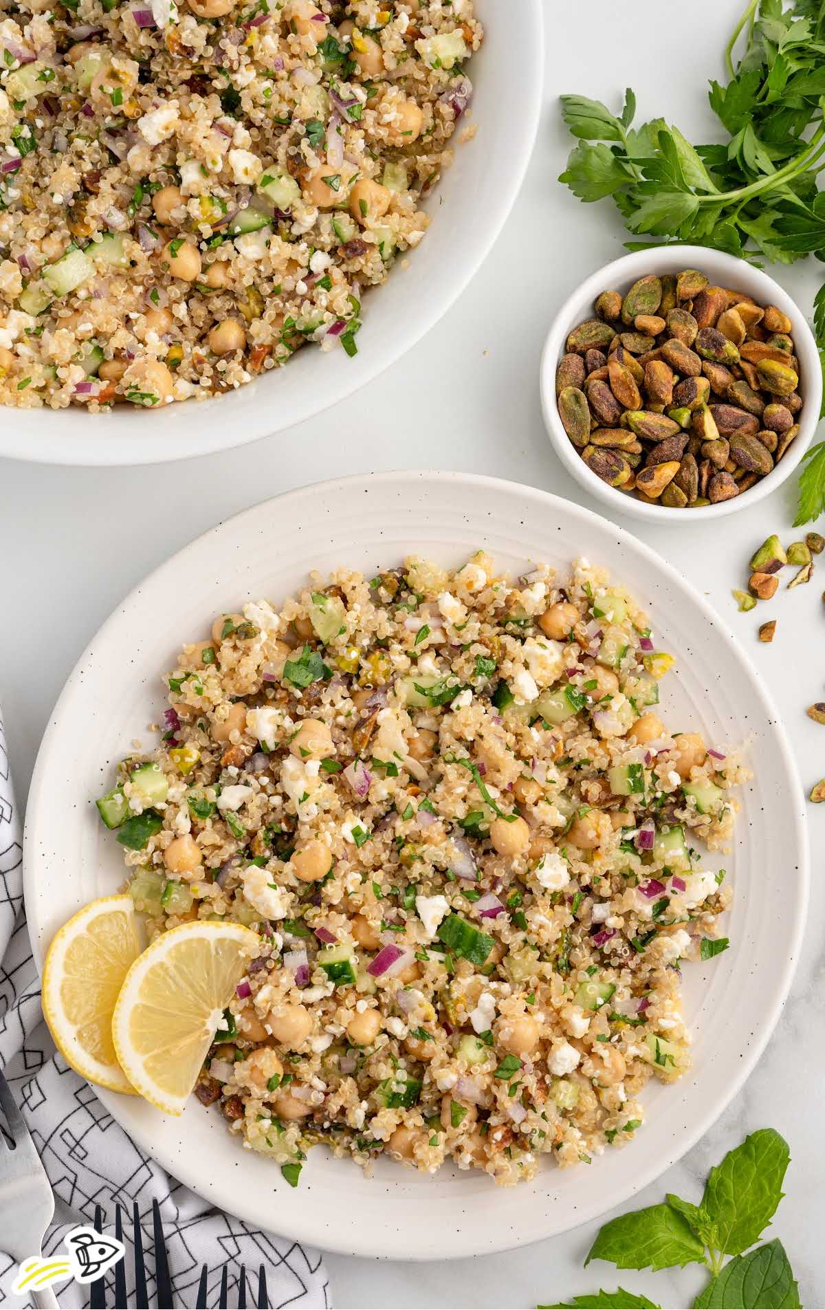 a plate of Jennifer Aniston Salad with slices of lemon