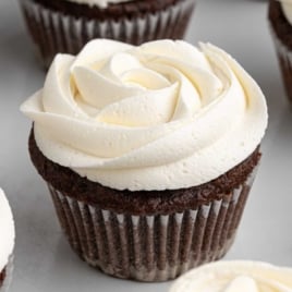 Close-up of chocolate cupcake decorated with rose swirl marshmallow frosting