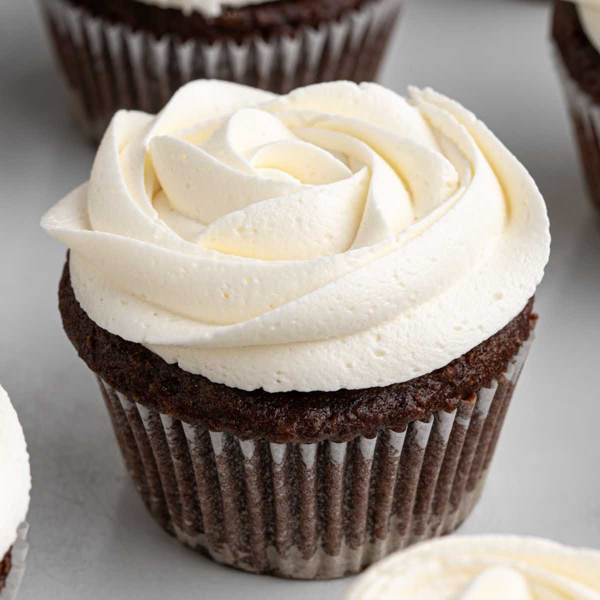 Close-up of chocolate cupcake decorated with rose swirl marshmallow frosting