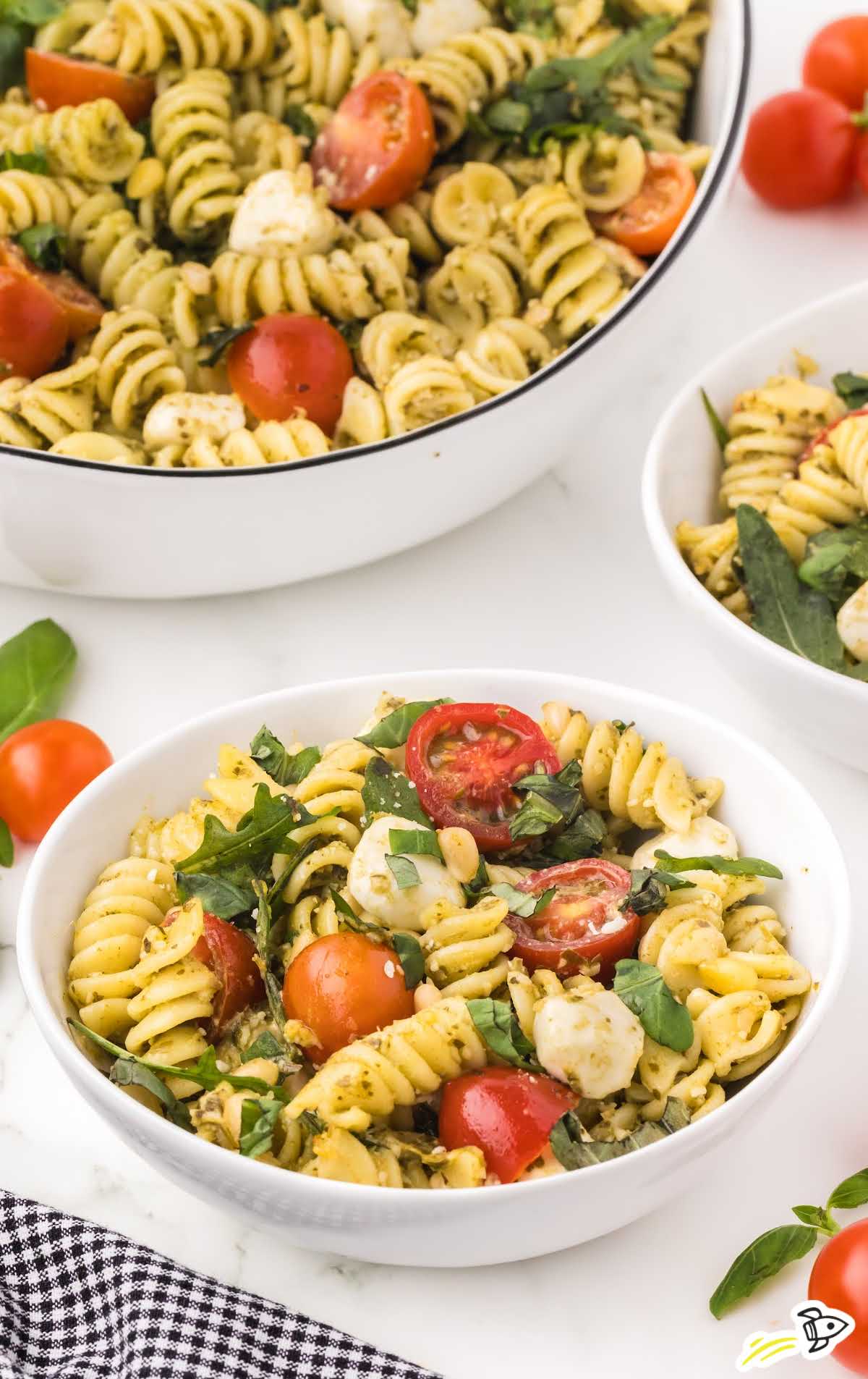 a bowl of Pesto Pasta Salad topped with basil