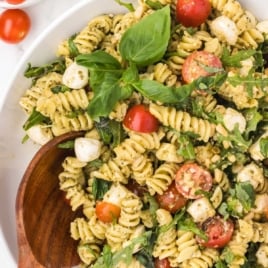 a bowl of Pesto Pasta Salad topped with basil