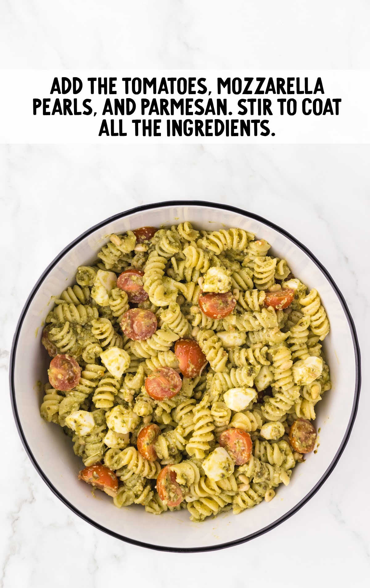 cherry tomatoes, fresh mozzarella balls, and grated parmesan cheese added to the bowl