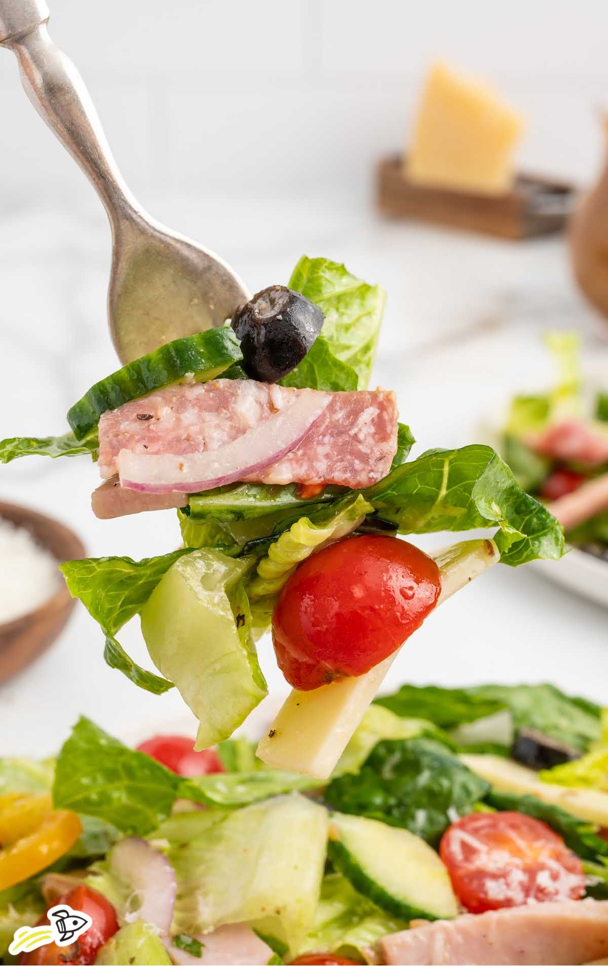 a forkful of Sandwich salad over a bowl 