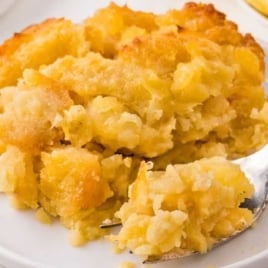 a plate of Scalloped Pineapple with a fork