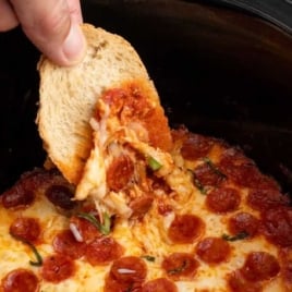 a Slow Cooker of Pizza Dip garnished with basil