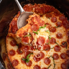 a Slow Cooker of Pizza Dip garnished with basil