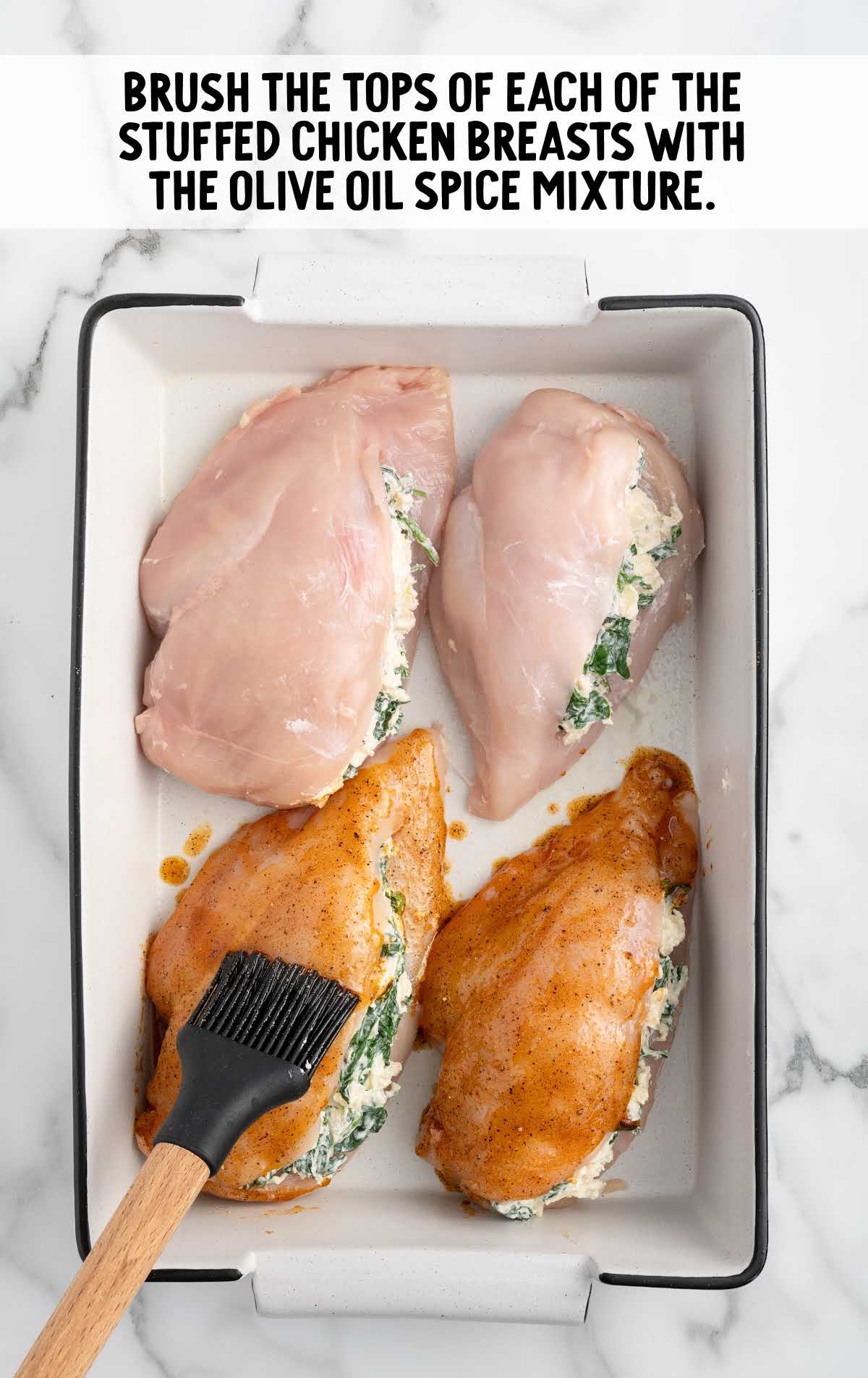 each stuffed chicken breast brushed with the olive oil spice mixture