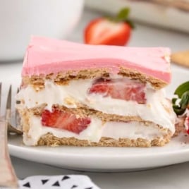 a slice of Strawberry Eclair Cake on a plate