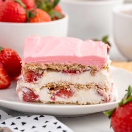 a slice of Strawberry Eclair Cake on a plate