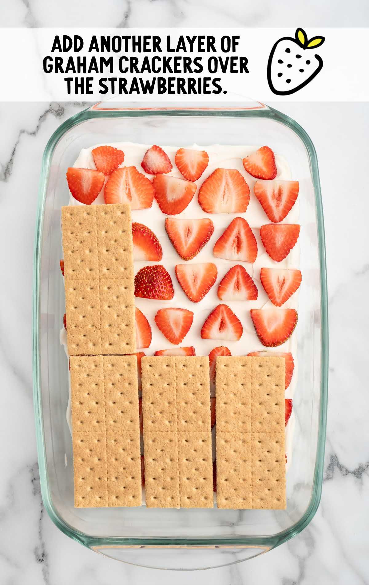 graham crackers layered over the strawberries