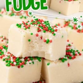 Sugar Cookie Fudge with christmas sprinkles stacked on top of each other