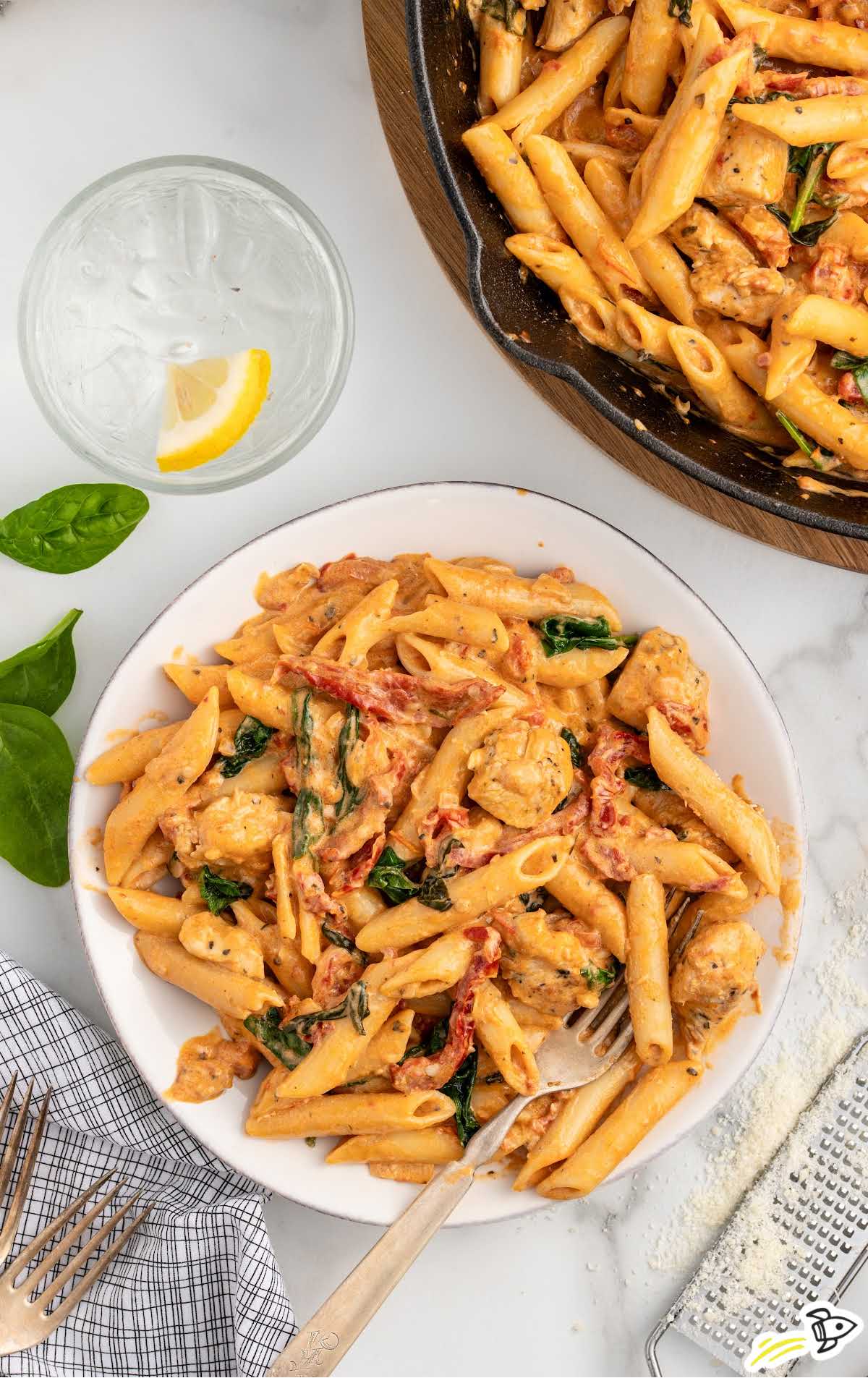 a plate of Tuscan Chicken Pasta with a fork