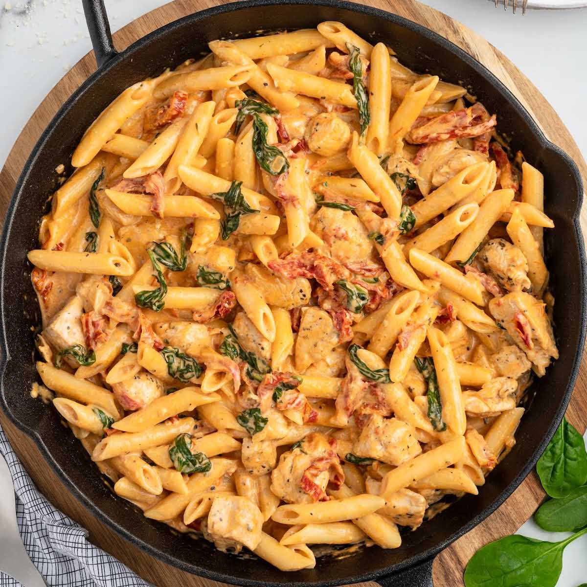 a skillet of Tuscan Chicken Pasta