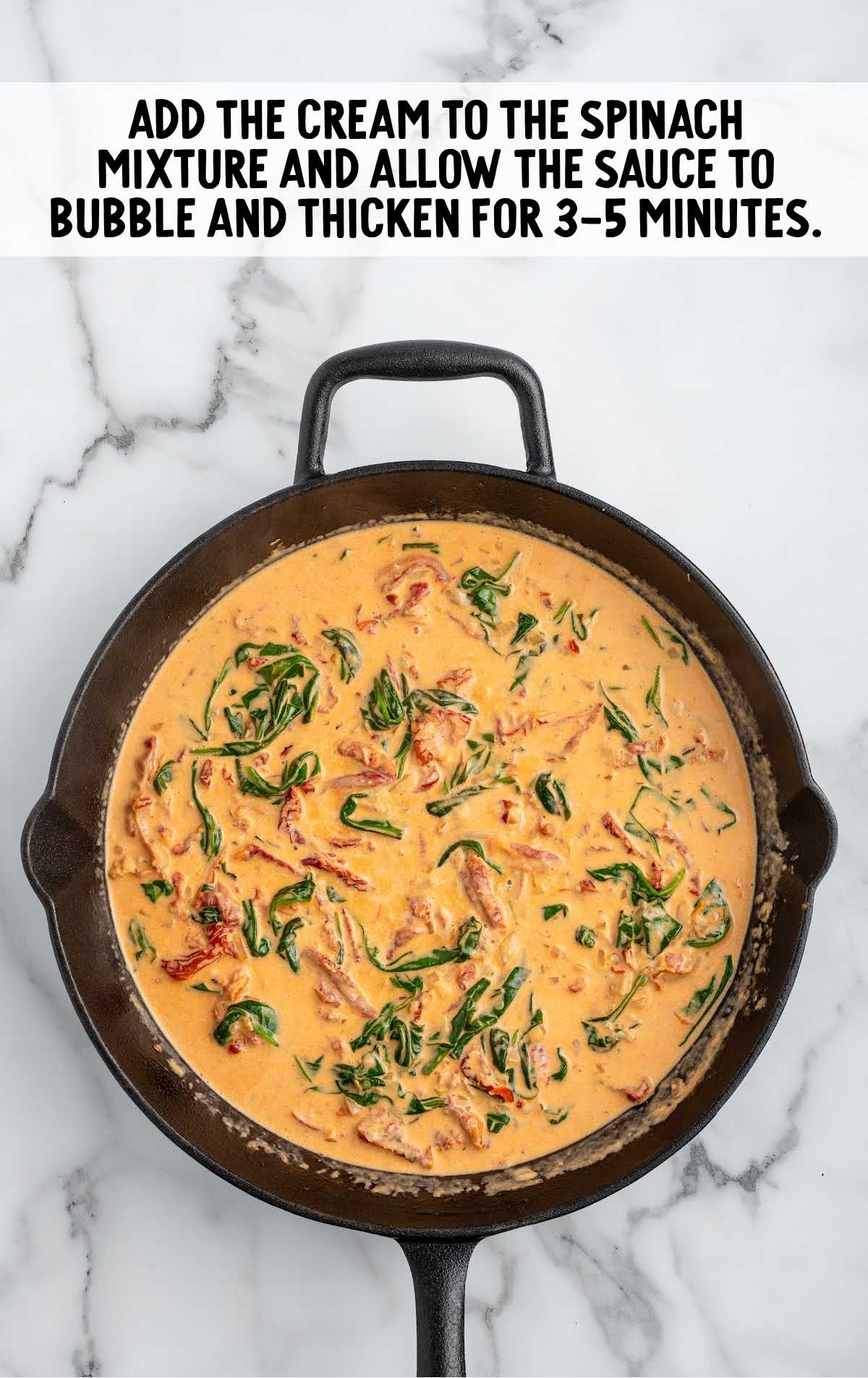 heavy cream added to the spinach mixture in the skillet